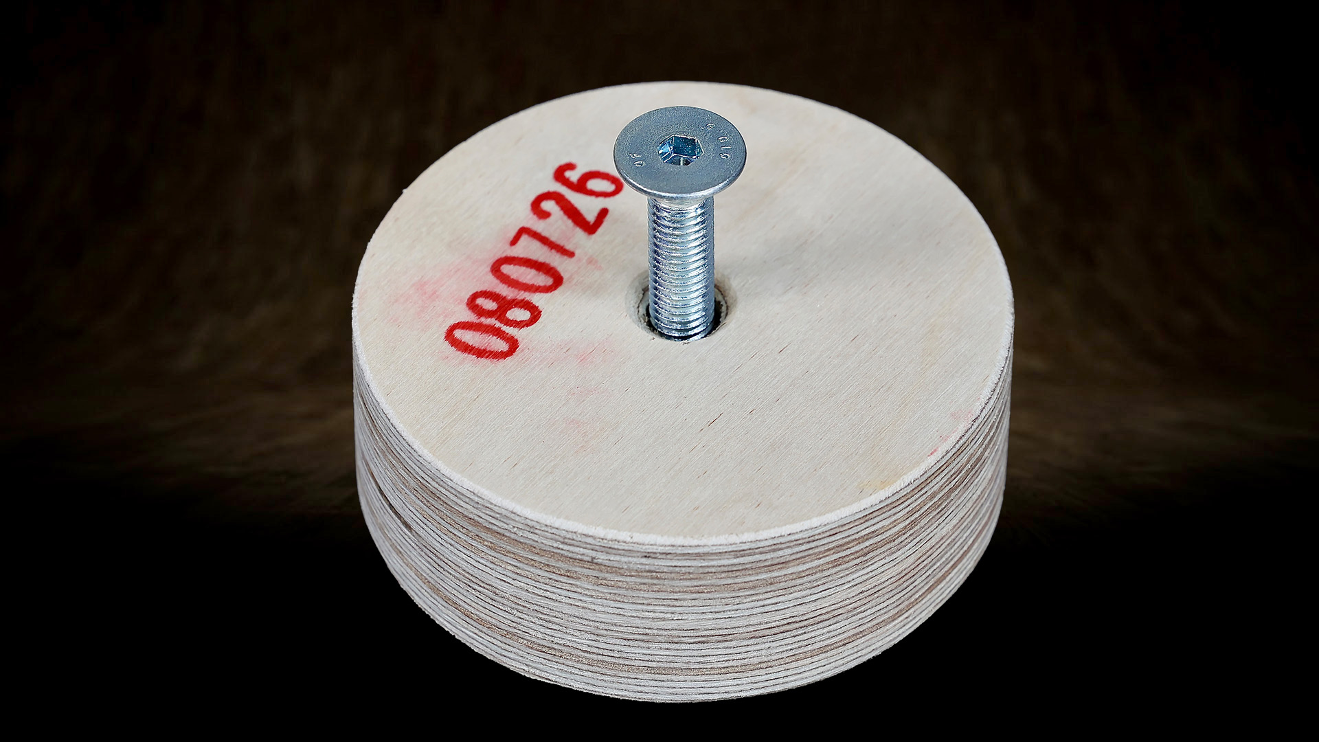 A multi-layer plywood insert with an embedded M10 T-nut.